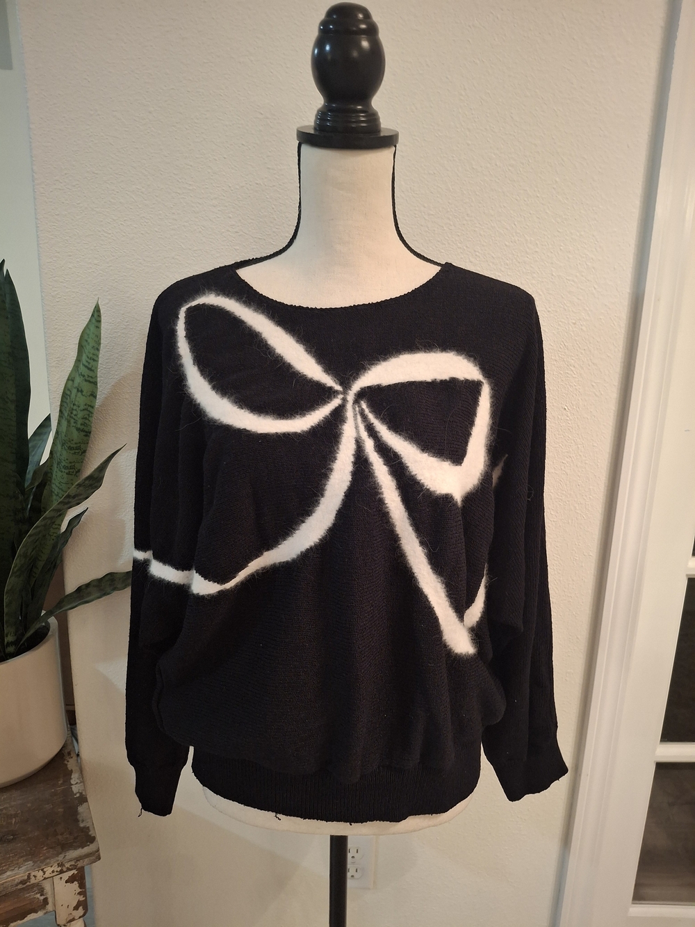Vintage Black Sweater with White Bow Graphic